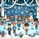 A colorful winter-themed paper craft scene featuring diverse paper cut-out children in winter attire. The children are surrounded by paper snowflakes, icicles, trees, a snowman, and ribbons against a blue background, creating a festive and playful atmosphere.