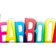 The image features the word "YEARBOOK" written in large, bold, overlapping letters. Each letter is a different bright color, including blue, yellow, red, and green, creating a vibrant, multicolored effect. The overlapping of the letters gives a slightly transparent and layered appearance. The background is plain white, which makes the colorful text stand out prominently.