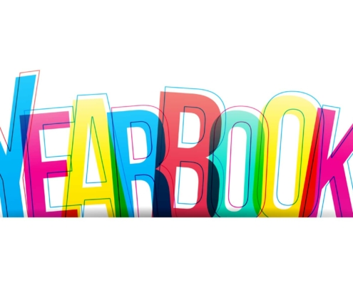 The image features the word "YEARBOOK" written in large, bold, overlapping letters. Each letter is a different bright color, including blue, yellow, red, and green, creating a vibrant, multicolored effect. The overlapping of the letters gives a slightly transparent and layered appearance. The background is plain white, which makes the colorful text stand out prominently.