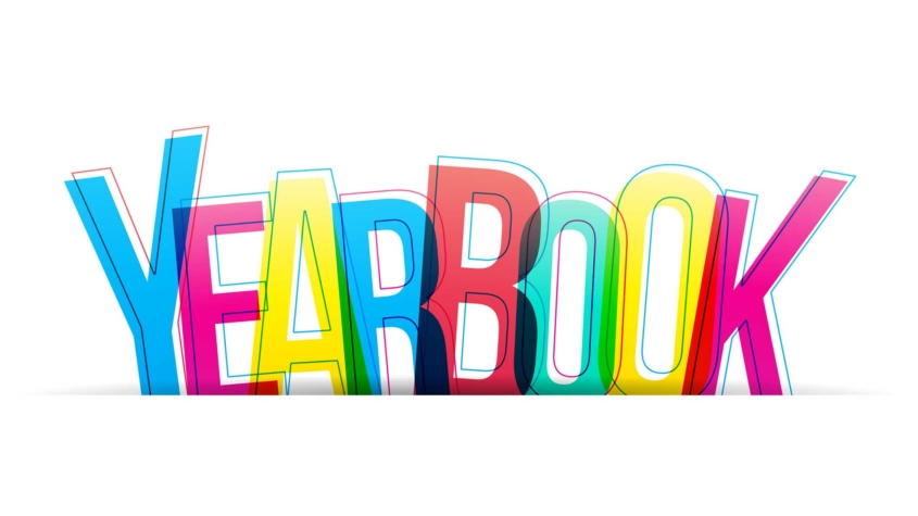 The image features the word "YEARBOOK" written in large, bold, overlapping letters. Each letter is a different bright color, including blue, yellow, red, and green, creating a vibrant, multicolored effect. The overlapping of the letters gives a slightly transparent and layered appearance. The background is plain white, which makes the colorful text stand out prominently.